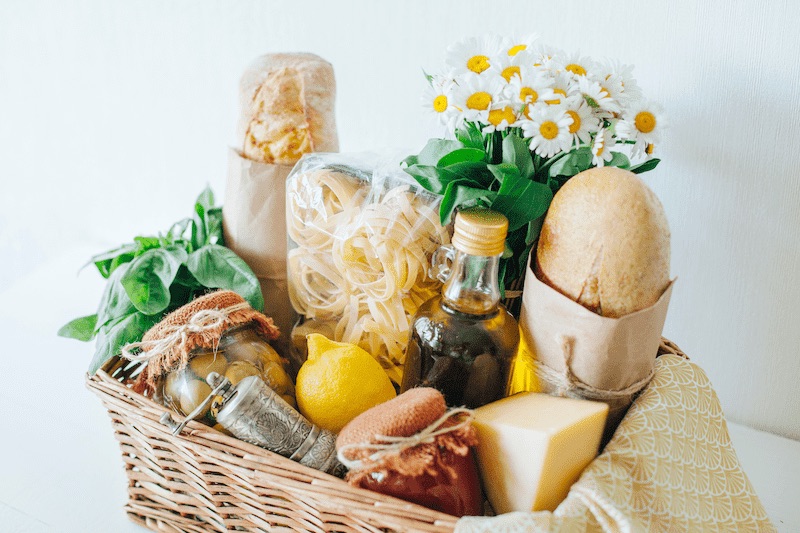 Meal basket with bread, flower, cheese